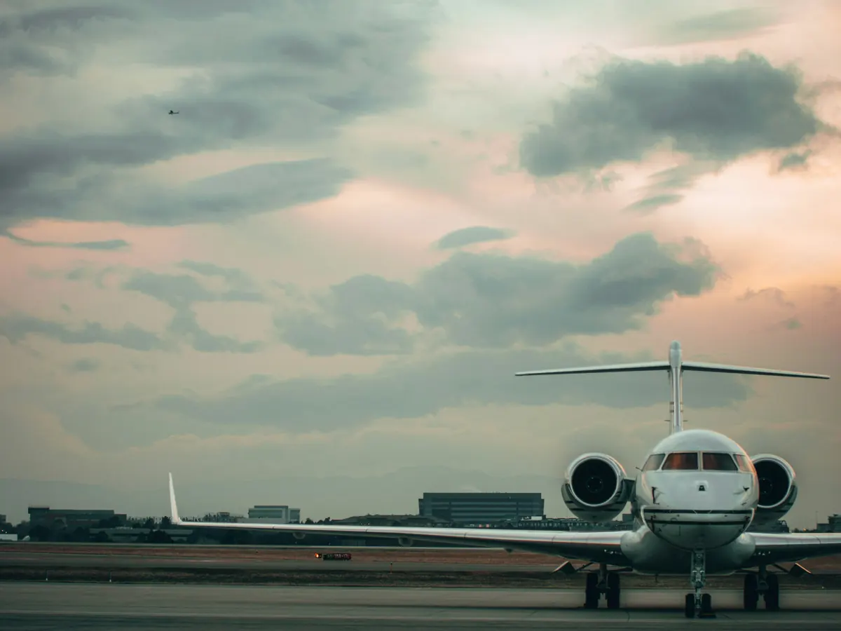 Business jet parked on an apron under an evening sky