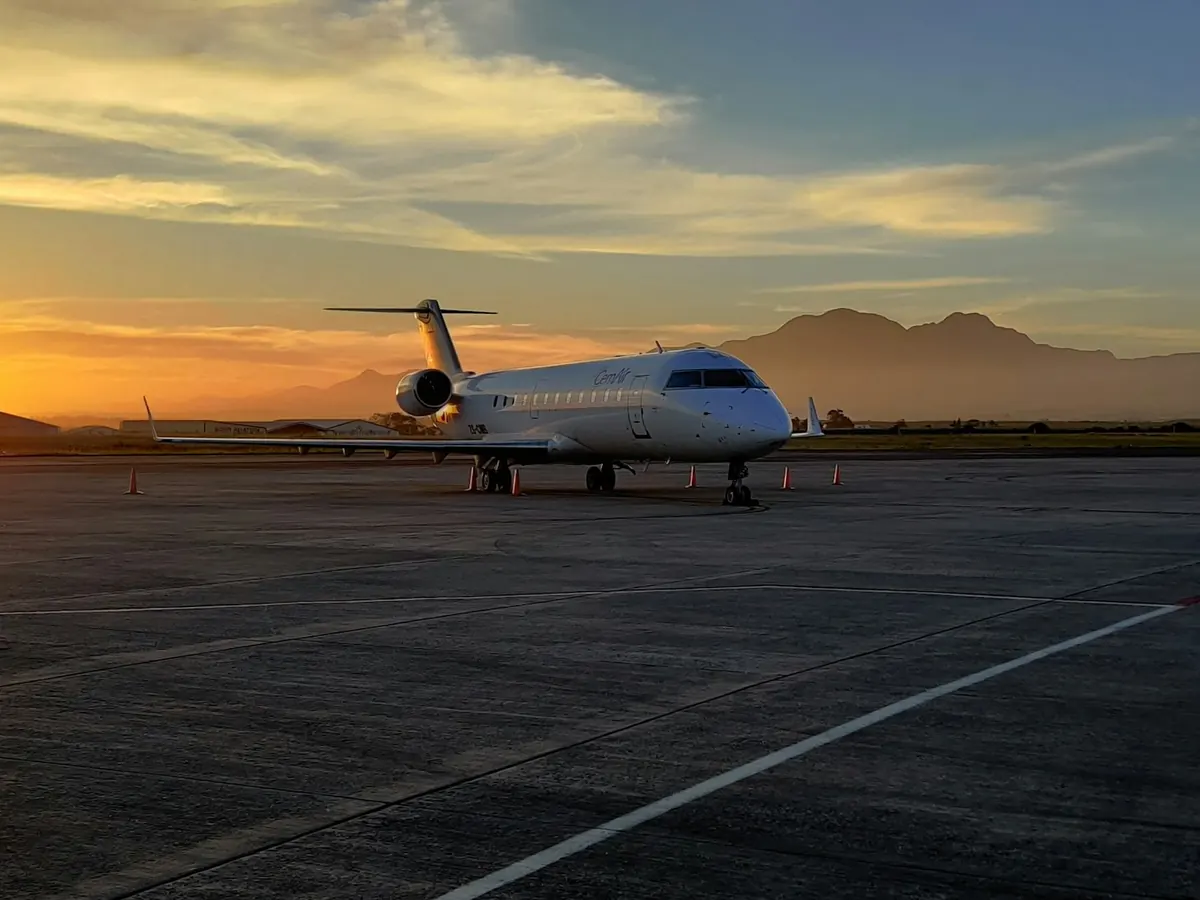 Business jet on a runway at sunset