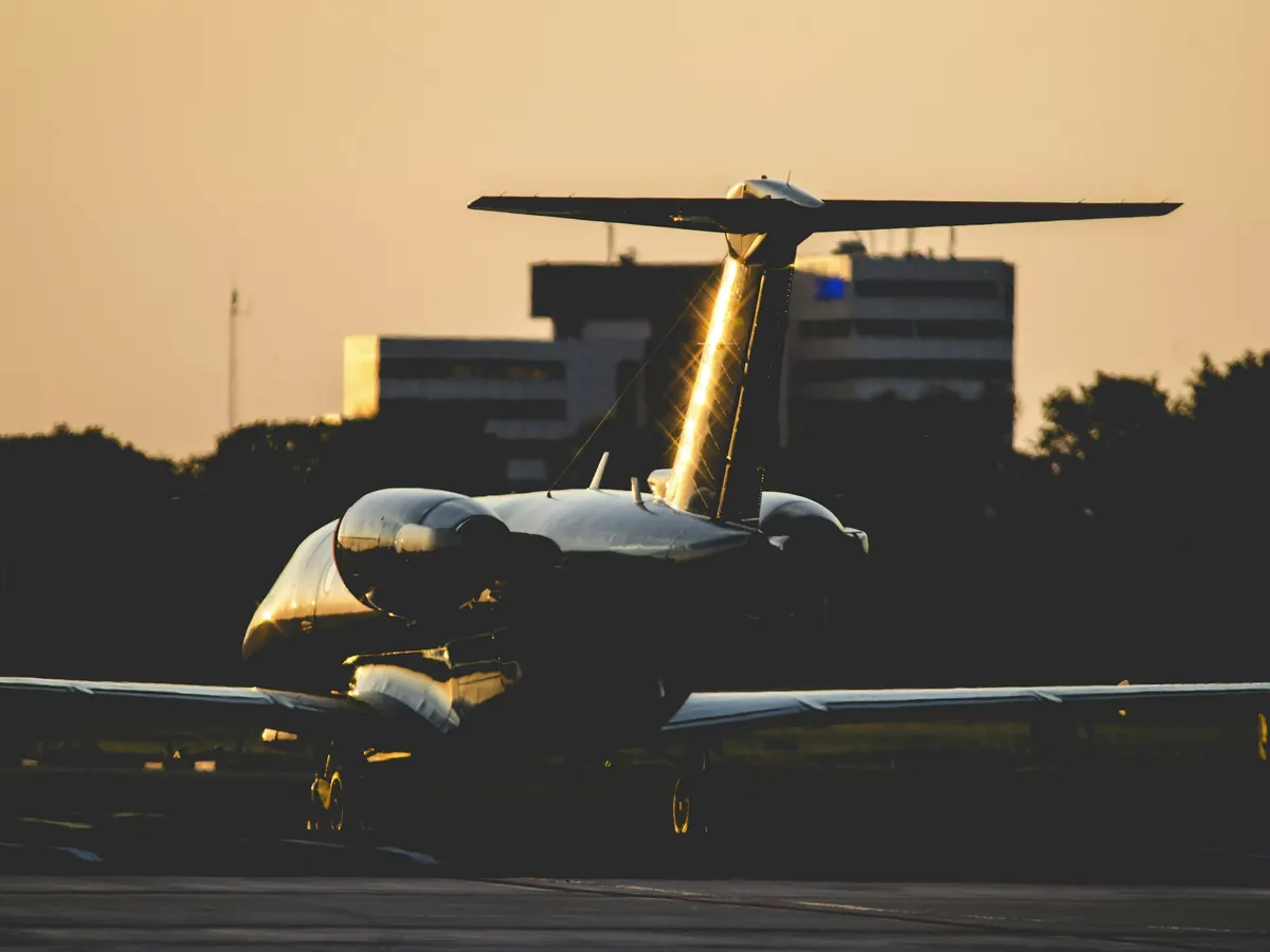 Business jet lit up on the ramp at night
