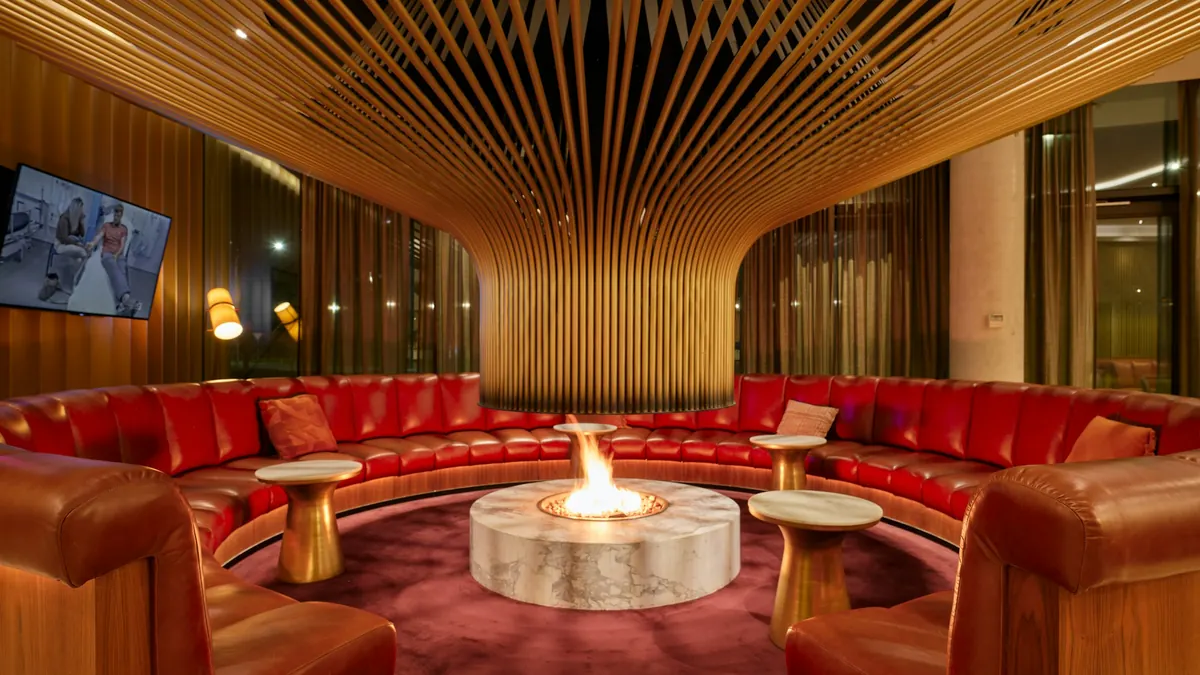 Lounge with a fireplace and red velvet seating